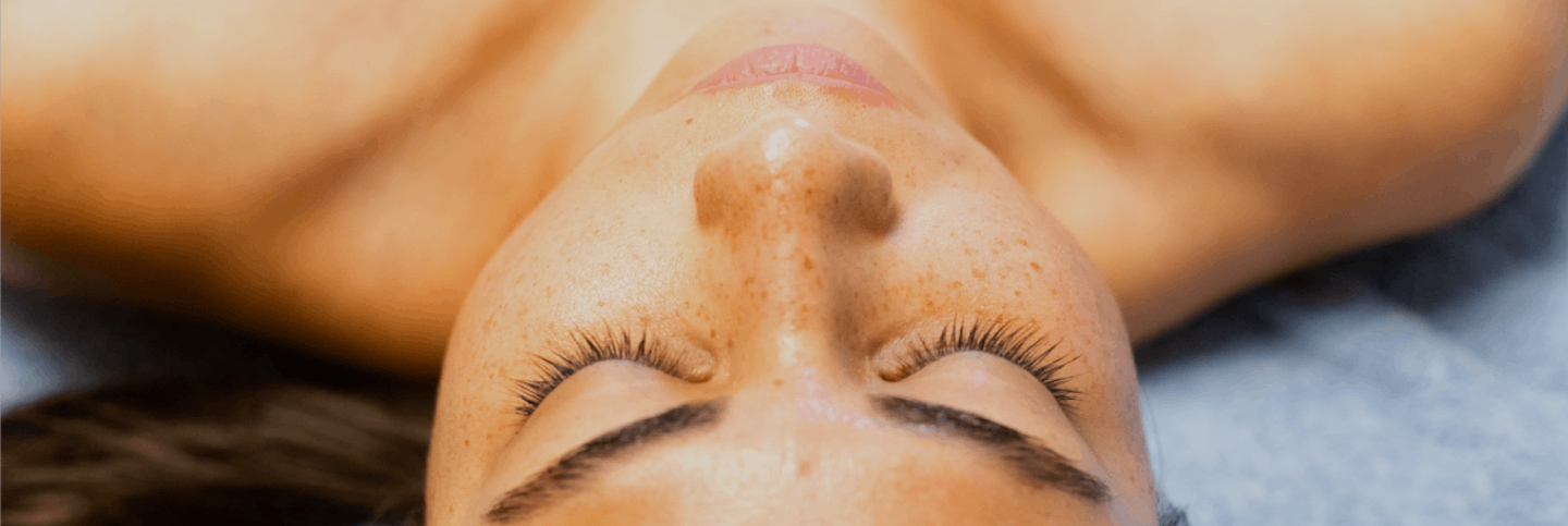 close-up of woman's face lying on a spa table